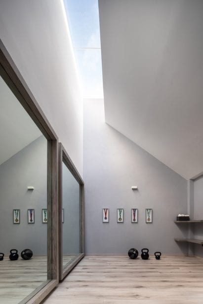 Home gym above a car collection in Morelia, Mexico