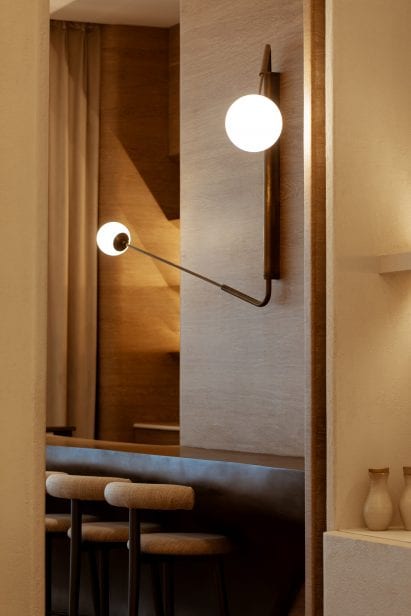 Spherical lights and counter seating in Sequel restaurant interior