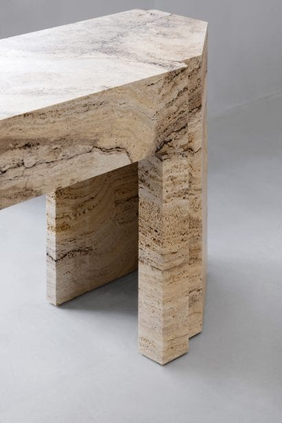 Close-up of travertine stone table in Axel Arigato Paris store