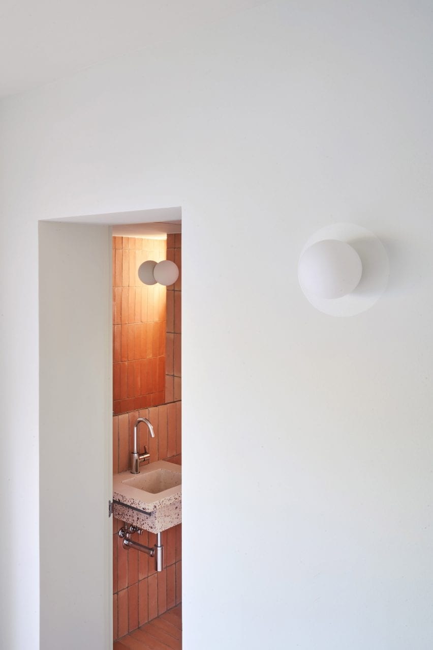 The bathroom is accessed by an opening in a wall