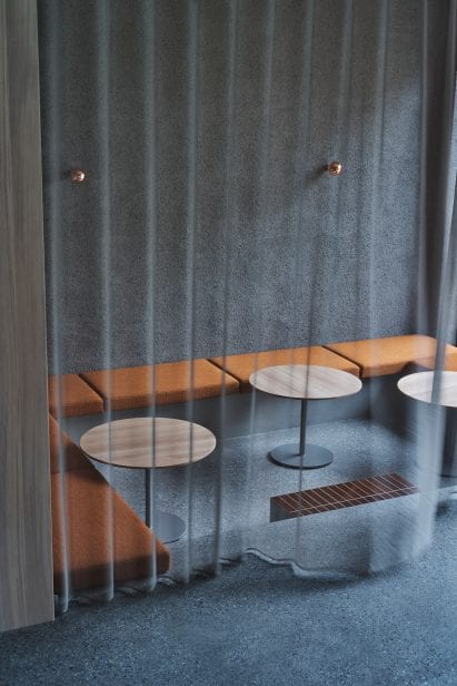 Sheer grey curtain over sunken seating area in Blue Bottle Coffee Shibuya