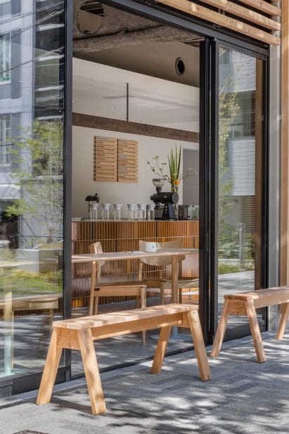 Wooden benches outside coffee shop by Keiji Ashizawa Design
