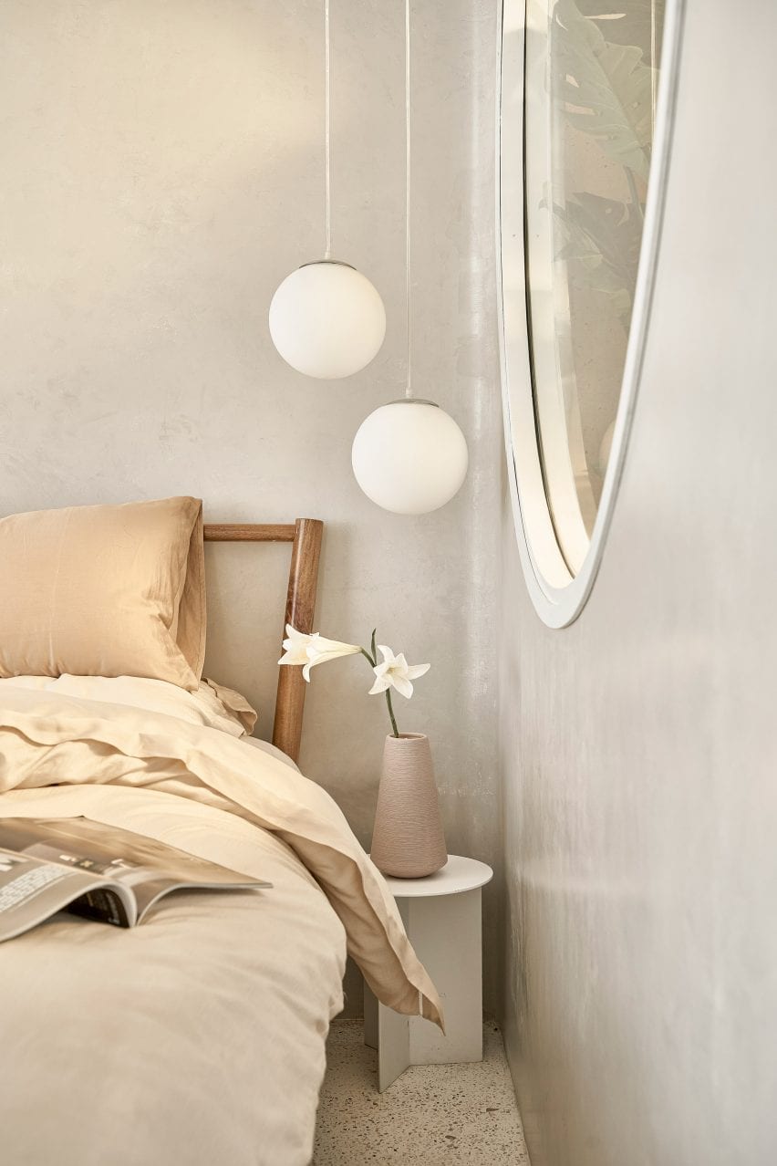 Pendant lights are located beside the bed
