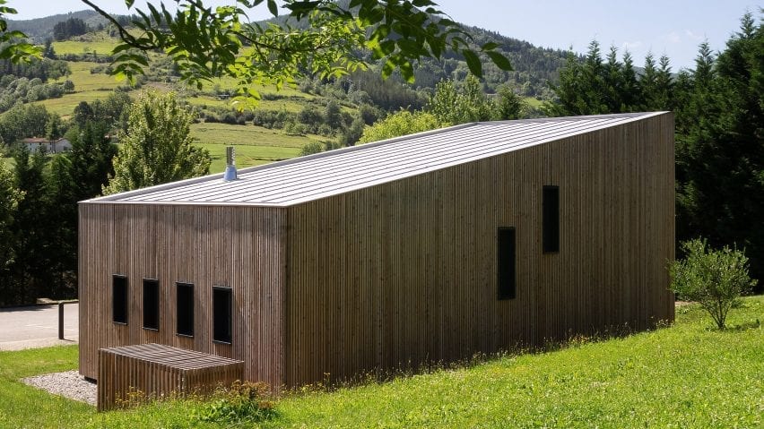 The building is surrounded by green hills