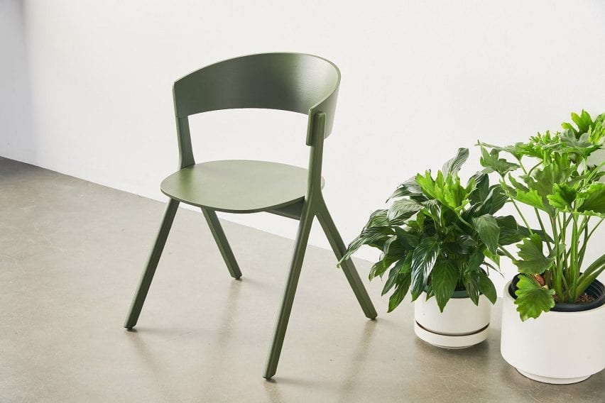 Green Circus Wood chair next to plants