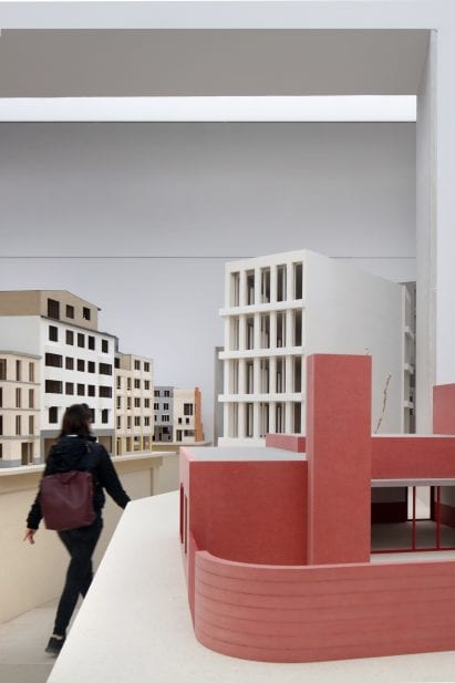 Visitor walking among models at Belgian Pavilion
