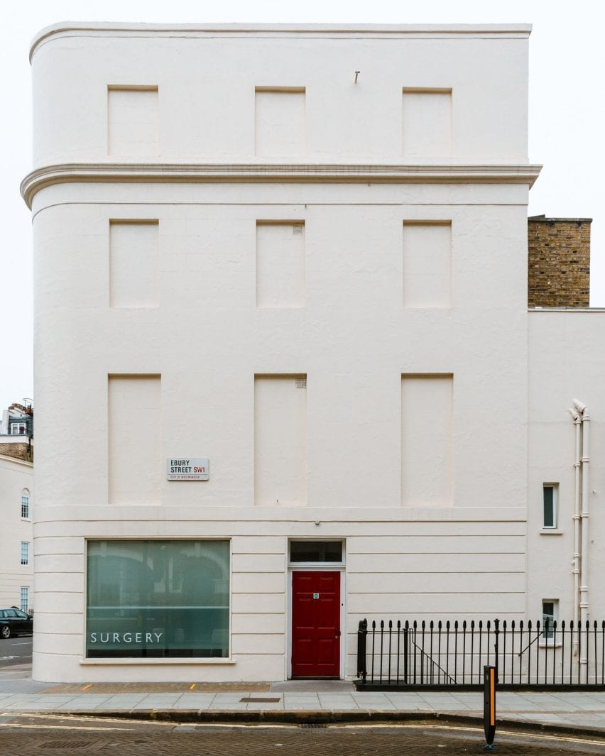 A windowless white facade of London housing
