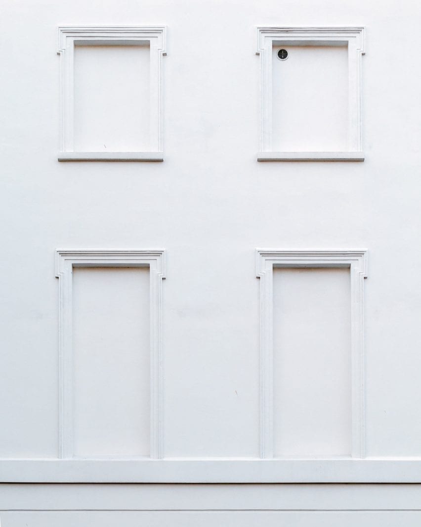 A windowless white facade