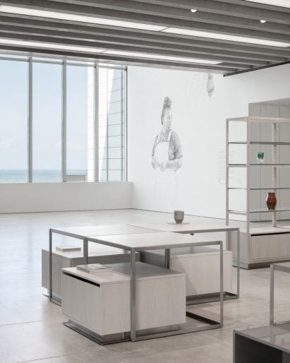 Store with panoramic view of ocean and vases on display shelves in interior designed by Daytrip