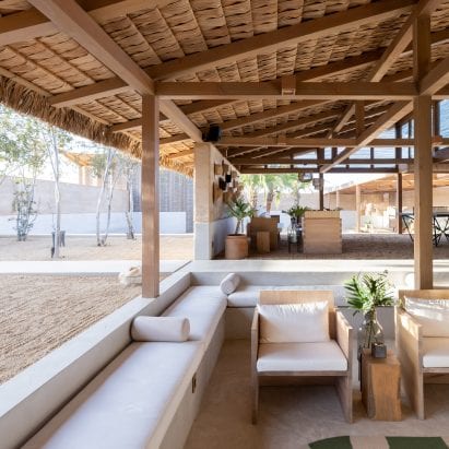 Estudio ALA designs El Perdido Hotel with rammed earth walls and thatched roofs
