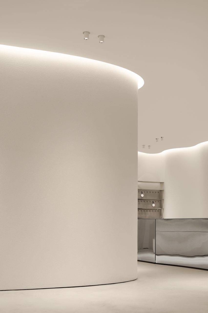 Curving walls are illuminated by strip lights