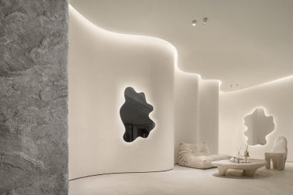 A togo sofa is placed beside undulating walls at ToSummer Living Room