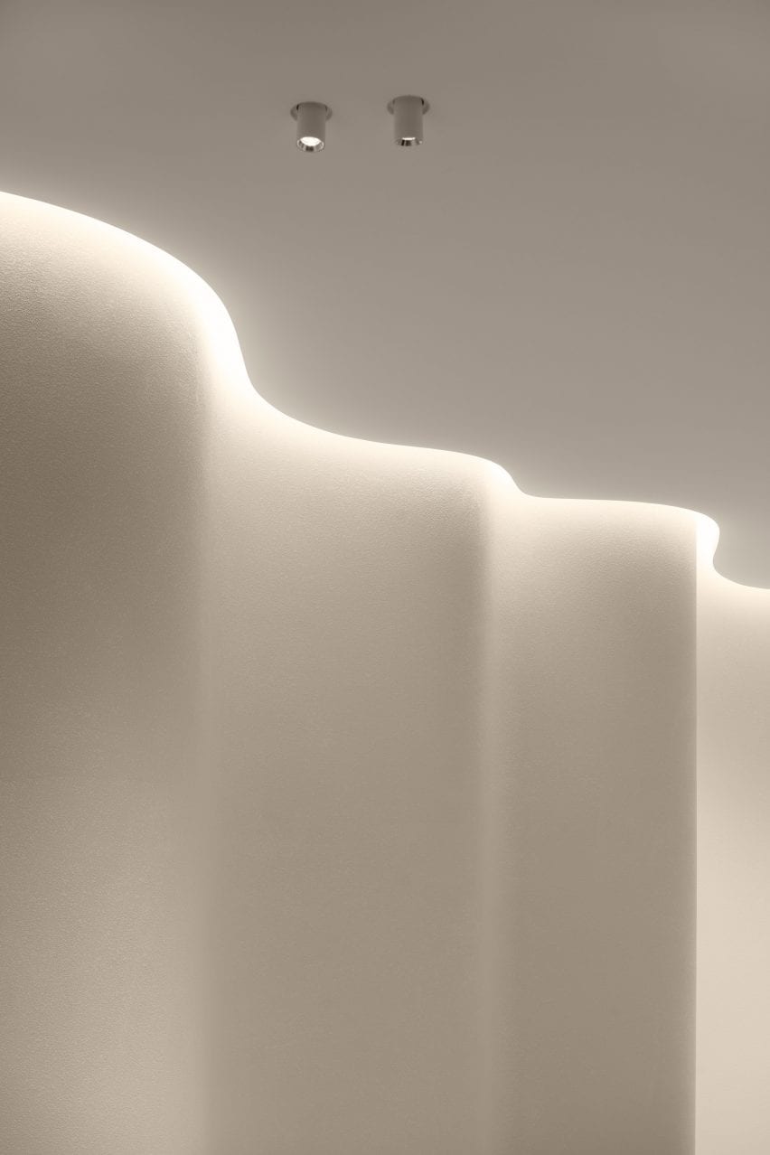 Lights create shadows across the curving walls