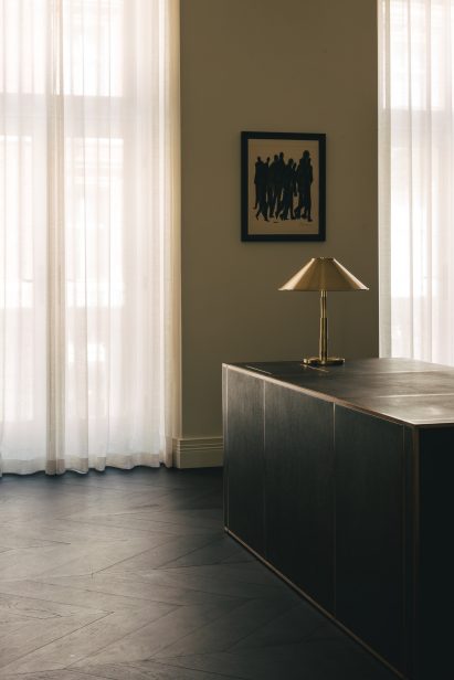 Black desk with gold lamp in Mandeville Place office