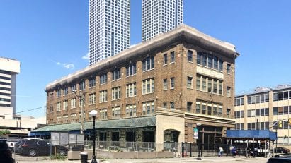 A glass canopy lines the side of the building