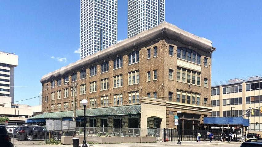 A glass canopy lines the side of the building