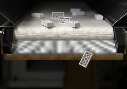 Recycled plastic lego bricks on a conveyor