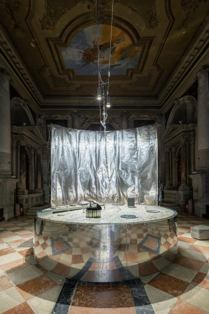 The plinth has a reflective mirrored surface