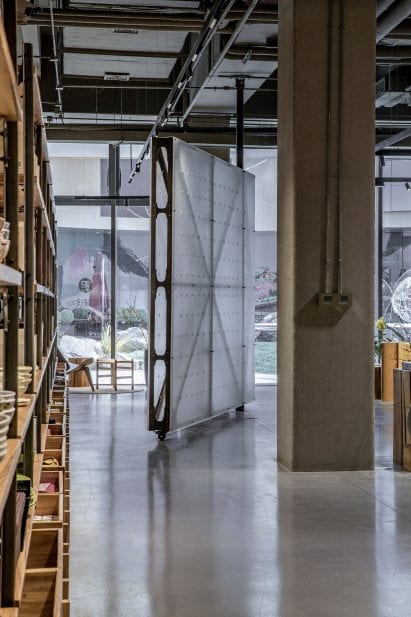 Translucent rotating wall on castors in Mumokuteki Concept Bookstore