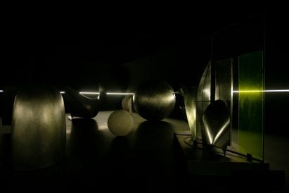 Gleaming metal art in a dark room