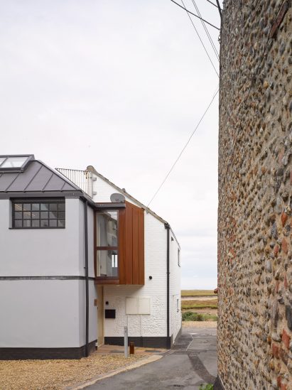 A corten volume at the rear overlooks the road