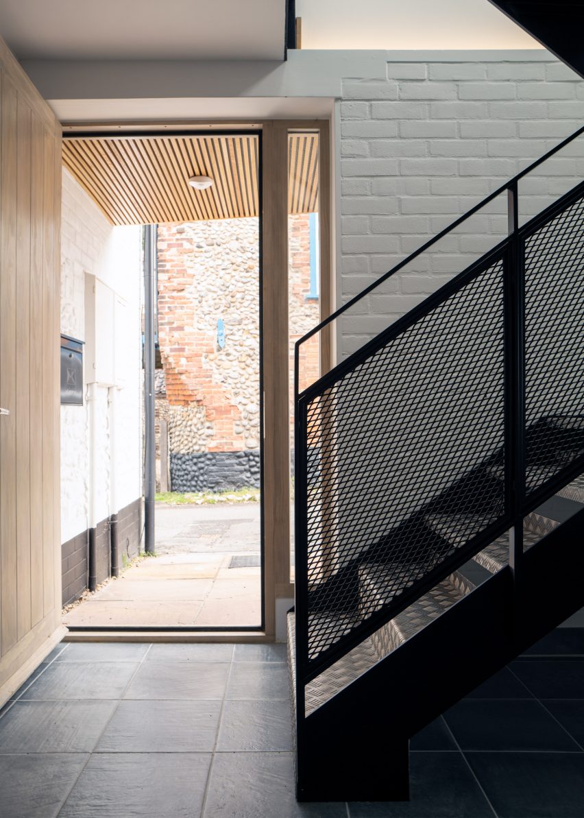 A mesh staircase leads to the upper level
