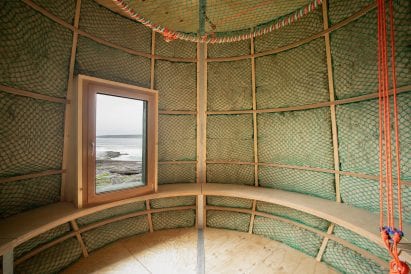 Timber structure of a hut with sheep's wool insulation