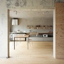 The kitchen is lined against a rendered wall