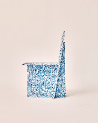 Side profile of speckled blue plastic chair by Peggy Gou and Space Available