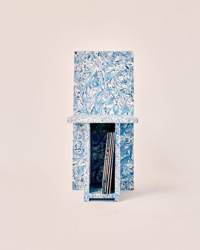 Front view of Trash to Chair with vinyls in under-seat storage unit