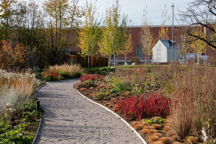 a gravel path leads to a garden shed