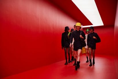Male models walking on the AMO red runway