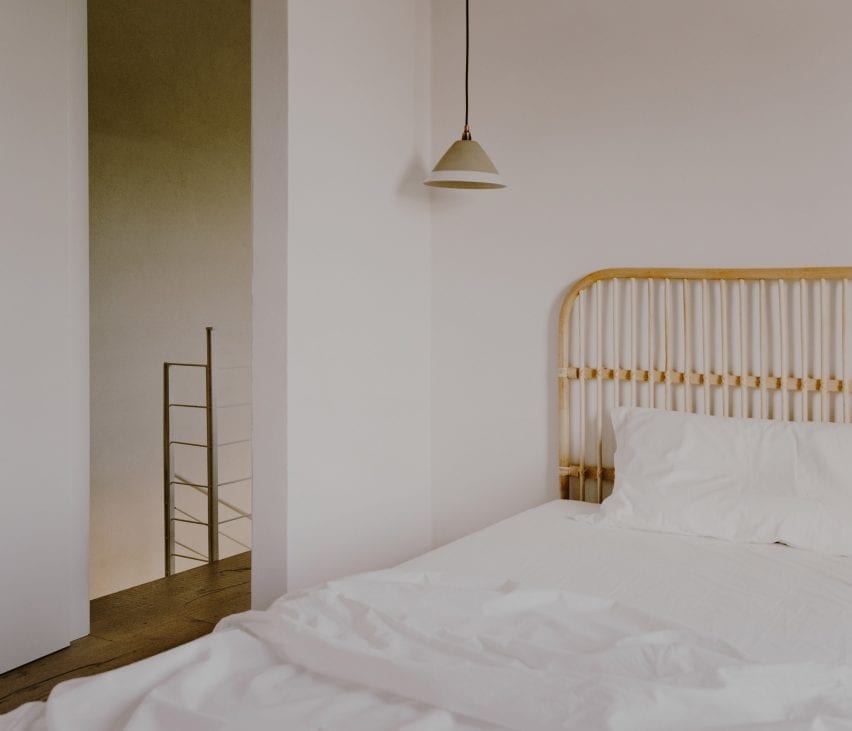A wooden headboard frames the bed