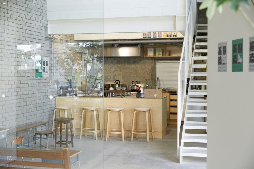 A light wood bar is nestled beneath a staircase