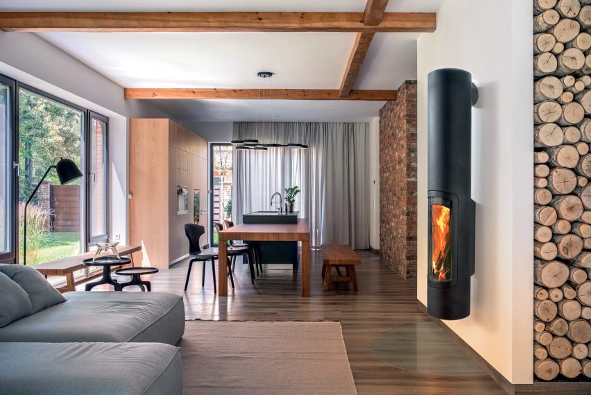 A black wall-mounted wood-burning fireplace