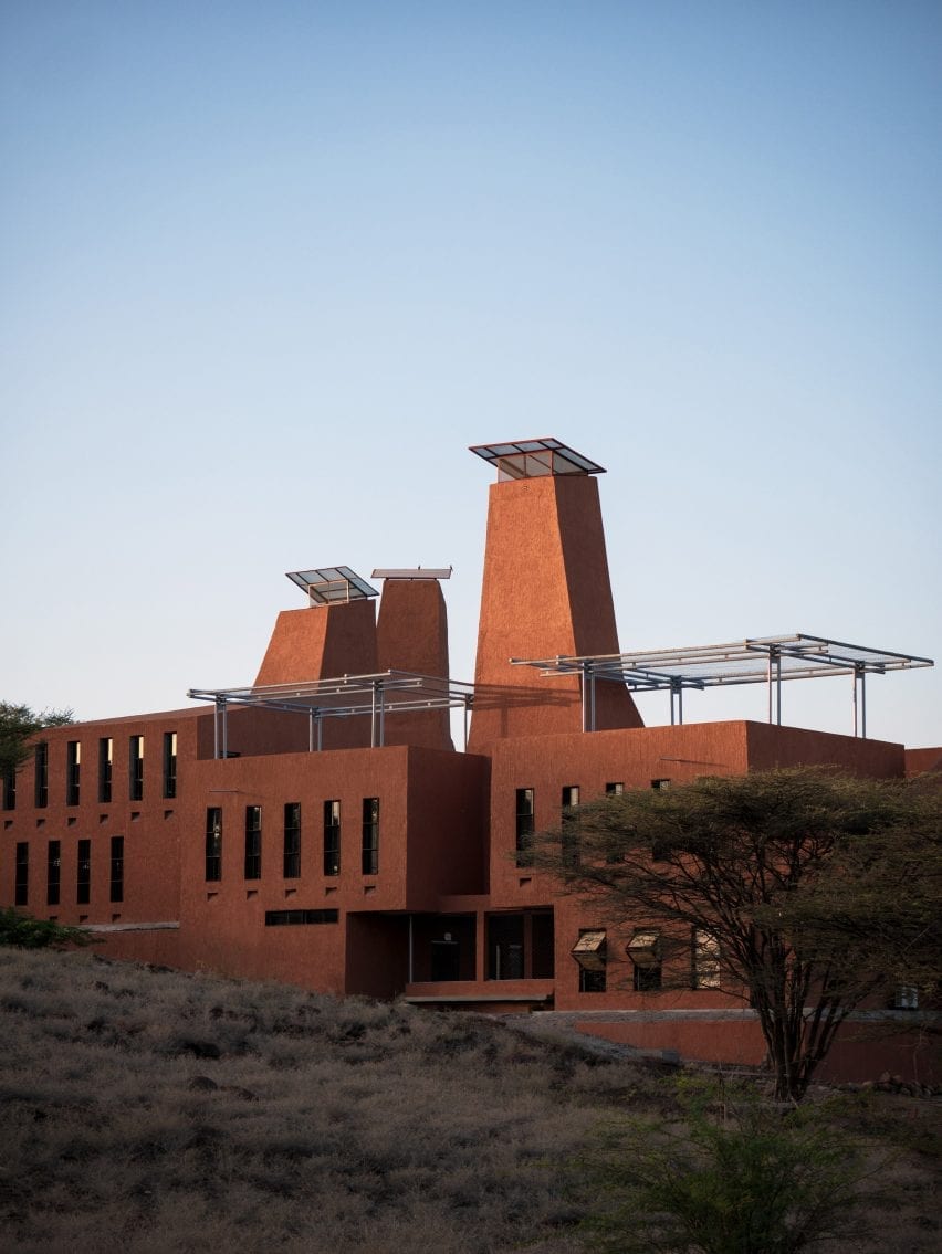 A building by Kéré Architecture covered in red plaster