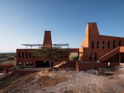 A building with a terracotta-hued plaster facade