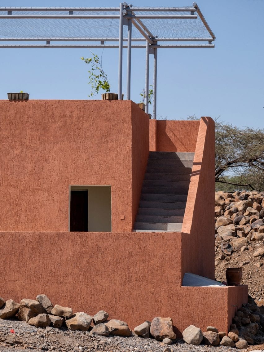 A facade finished in terracotta-hued plaster