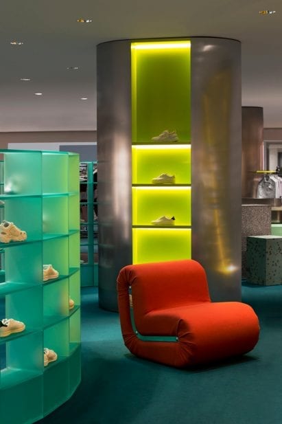 Illuminated display columns with red armchair in Rinascente womenswear department