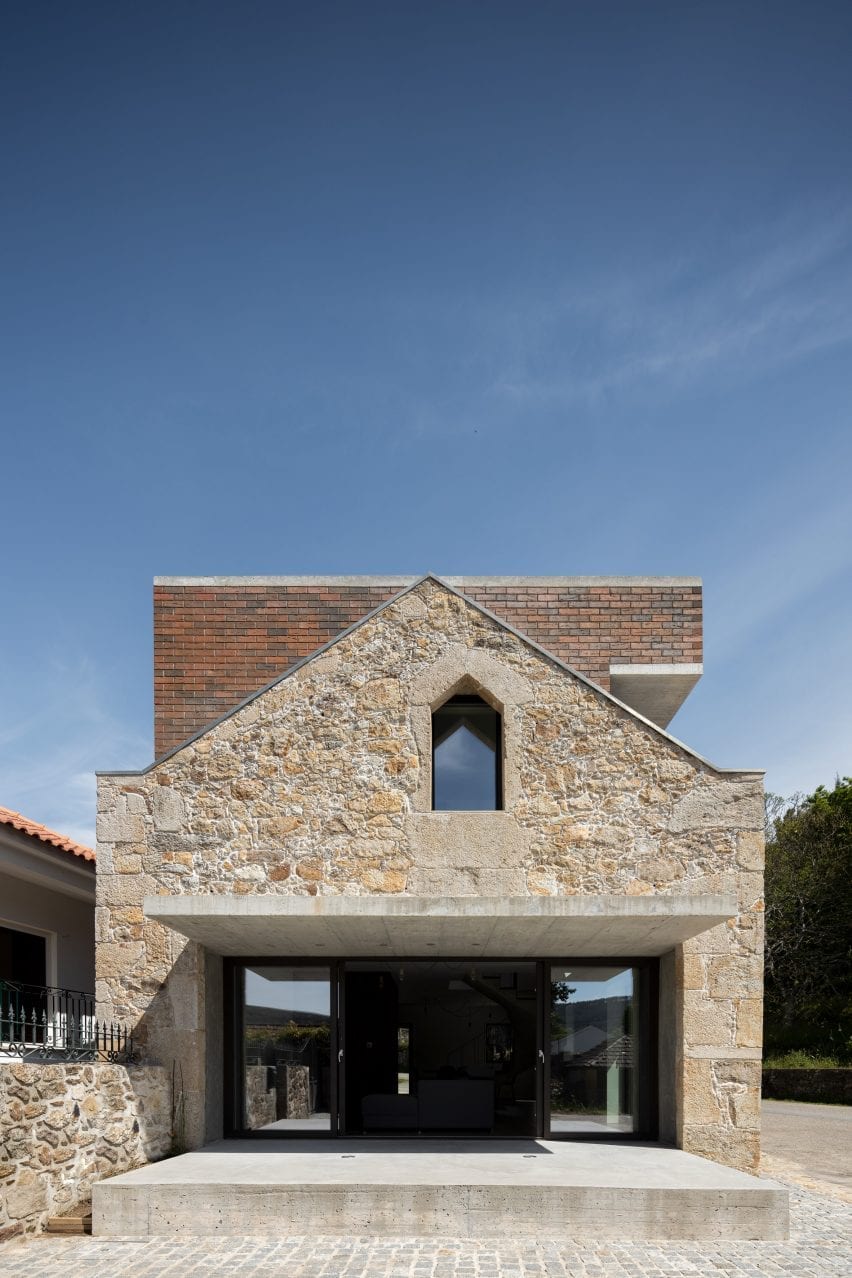A concrete canopy extend over a glazed wall