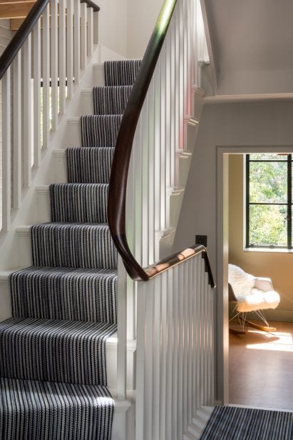 A striped runner lines the stairs