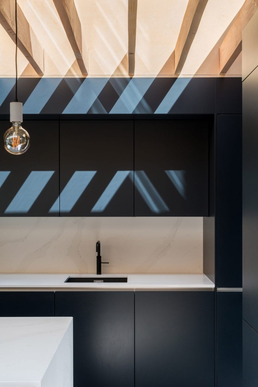 The kitchen has a dark design