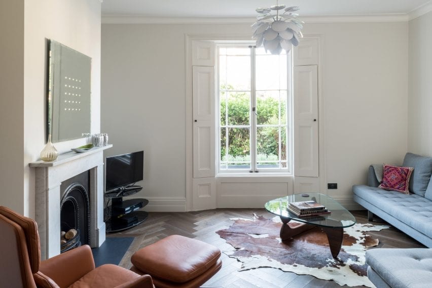 A living room has herringbone floors
