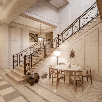 Staircase of Victoria House with seating area of wooden chairs and marble table