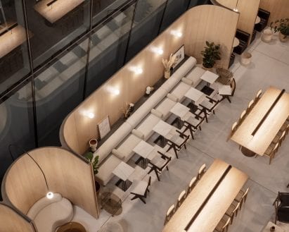 Office interior by Hutchison & Partners with communal wooden tables and upholstered bench seating