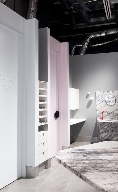 Marble accents and bright orange tap in Vision Studio interior