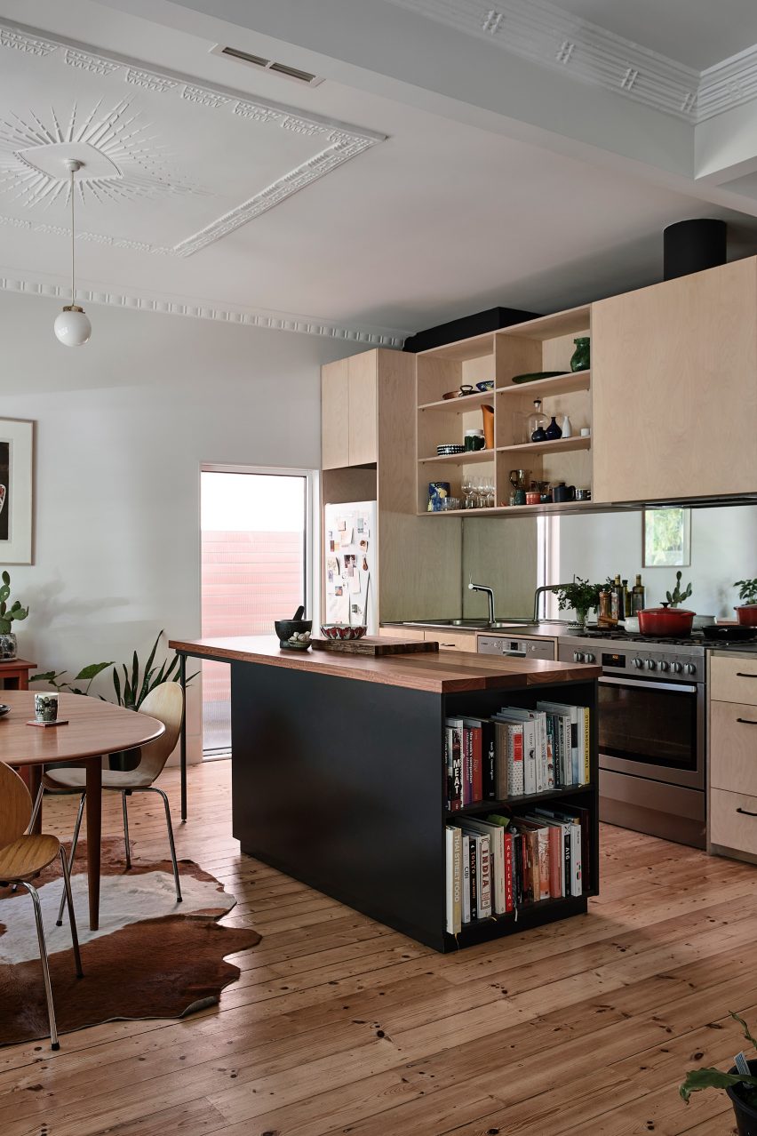 The kitchen in the existing home has a wood design