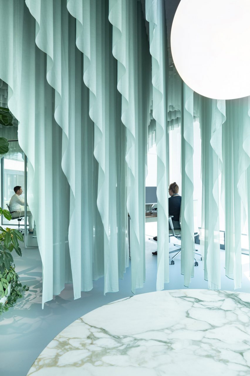 space between curtains provide views across the office