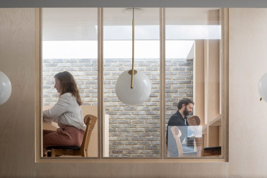 Window looking into mezzanines study room in Bravura House by Selencky Parsons