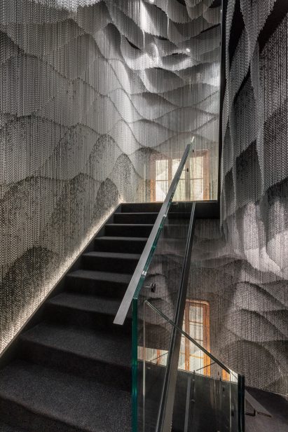 A staircase surrounded by metal-mesh